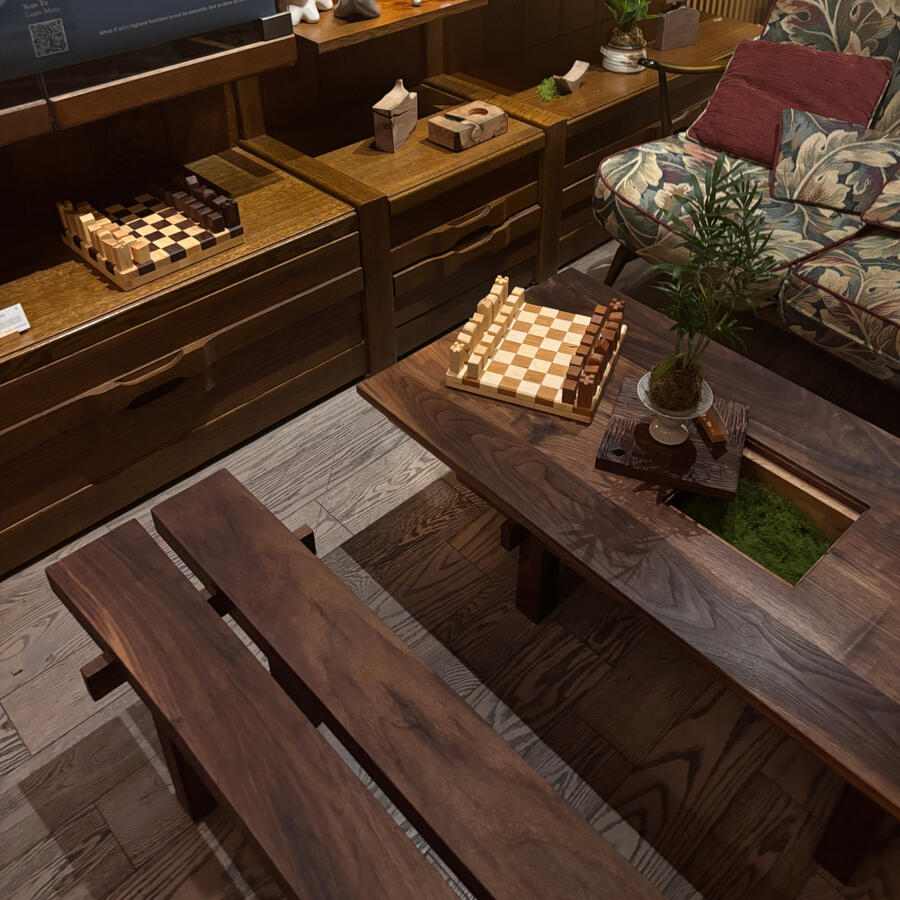 A view of the Temple's COURTYARD Coffee Table, Bench, and two (2) chess sets by Estudio GOO. Located at the Lost in Tokyo Cafe, on Queen Street West in Toronto.