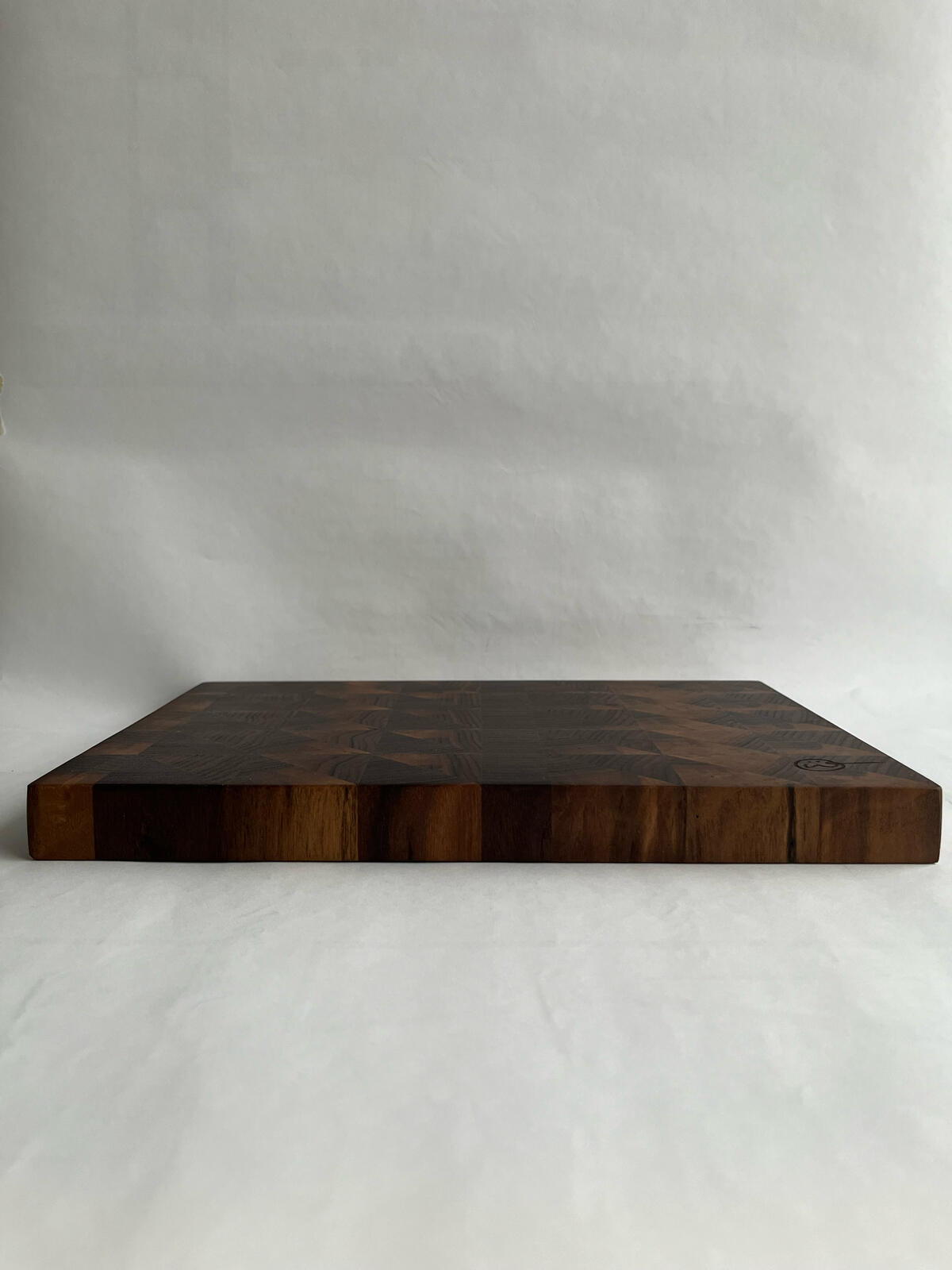 A photo showcasing a dresser table made out of cherry & maple wood.